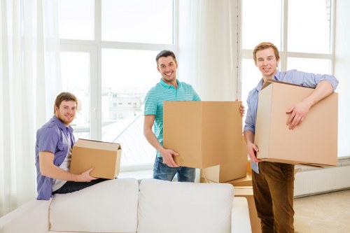 Fragile items and furniture being packed for relocation